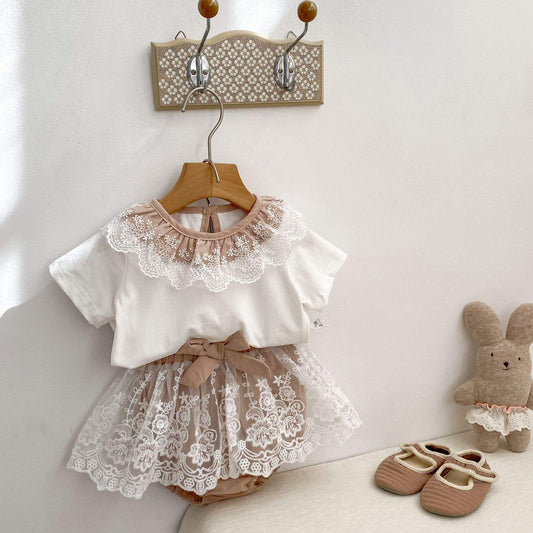Children's outfit with lace top and shorts hanging . Brown and white combo