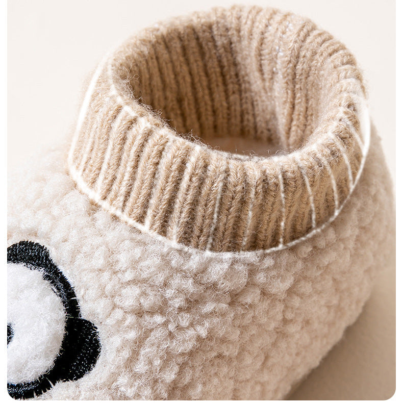 Beige slipper with panda design on a white background