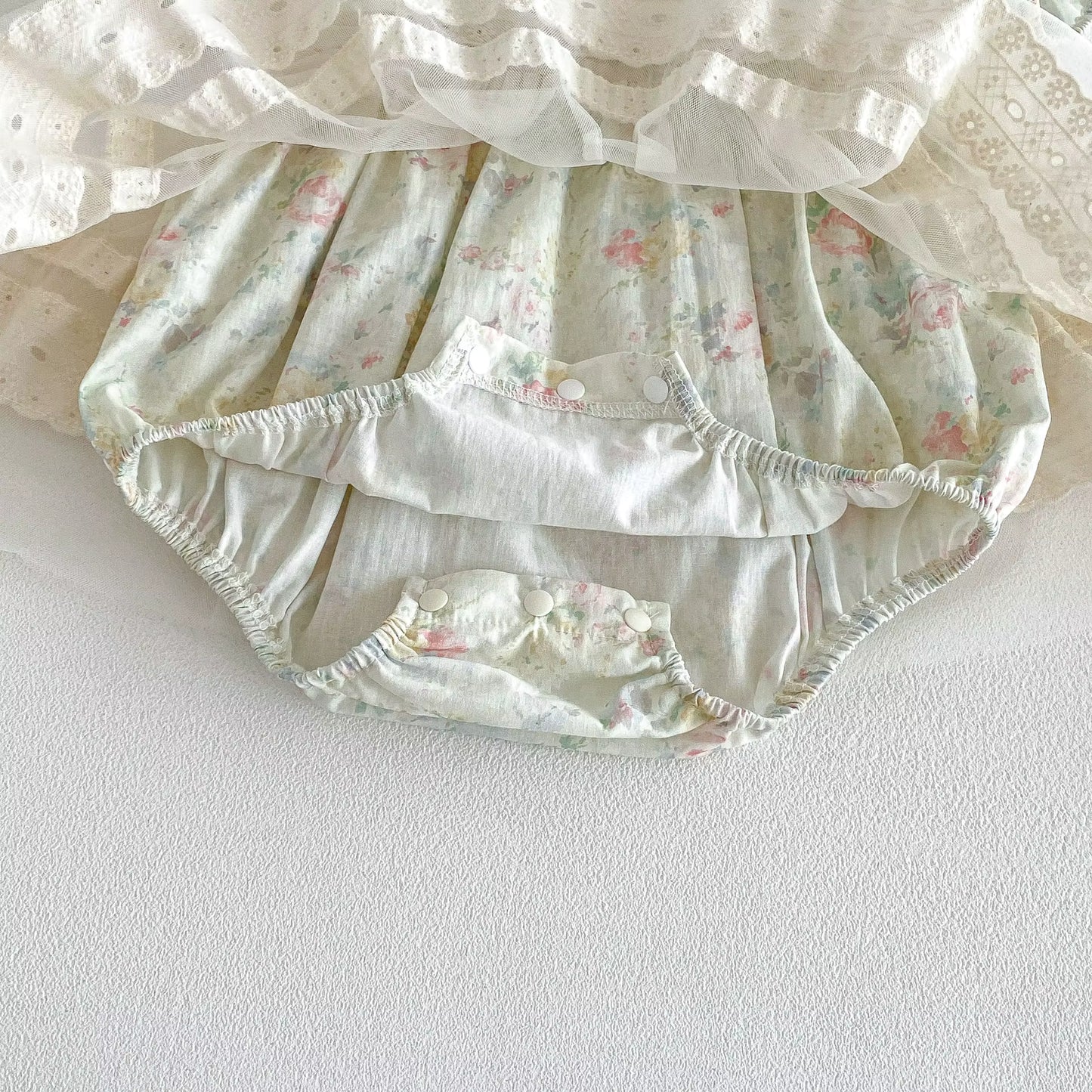Floral-patterned baby bloomers on a white background