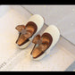 Pair of white shoes with brown bows 