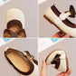 Collage of children's shoes with brown and white design, held by a hand.