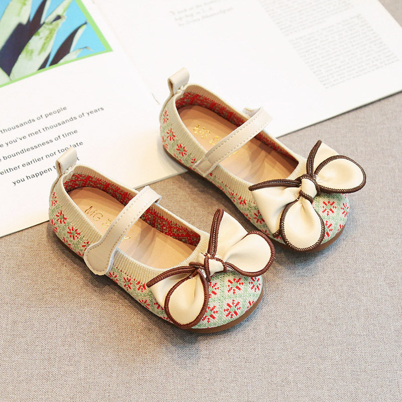 Pair of children's shoes with floral pattern and bow details by Crazy Toes