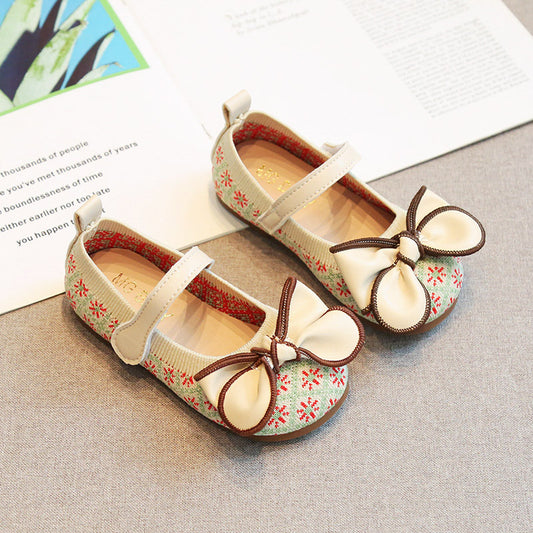Pair of children's shoes with floral pattern and bow details by Crazy Toes