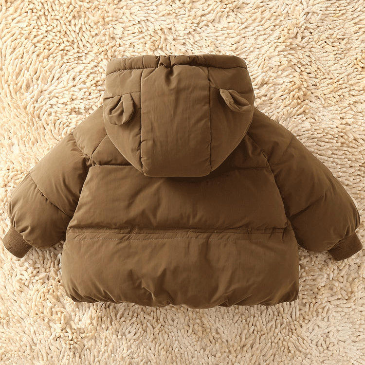 Brown puffer jacket with bear ears on a beige carpet
