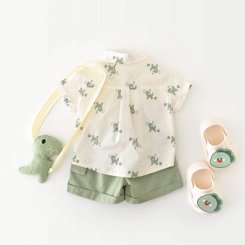 Children's outfit with shirt, shorts, and shoes featuring turtle patterns on a white background