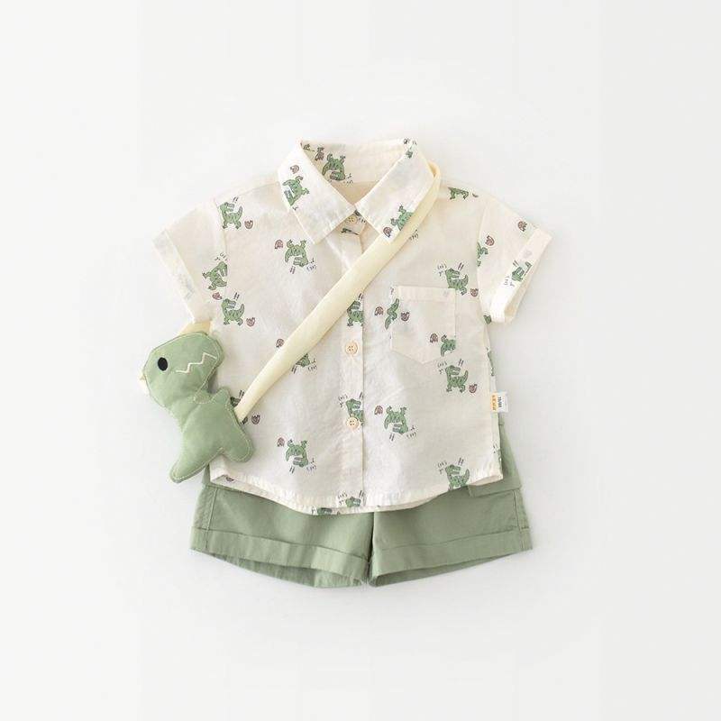 Children's outfit with shirt, shorts, and plush toy on a white background