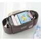 Brown organizer with baby items including books and clothes on a white surface.