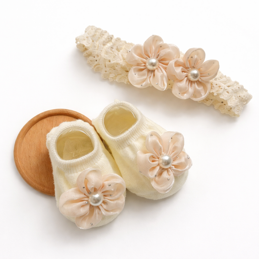 Baby shoes and headband set with floral designs on a white background