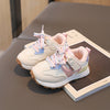 Pair of children's sneakers on a book with a blurred background