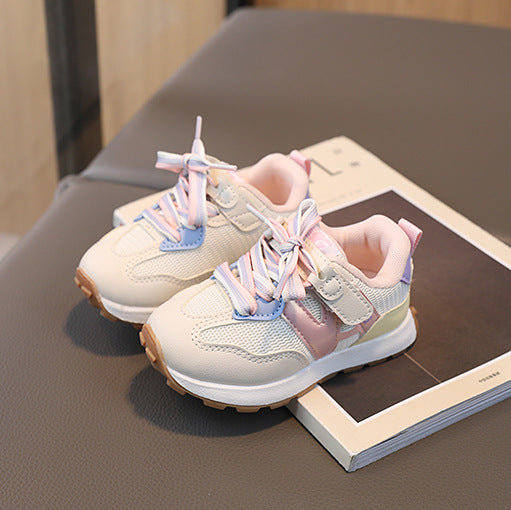 Pair of children's sneakers on a book with a blurred background