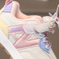 Pastel-colored children's sports shoe with visible brand name.