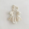 White lace baby romper with bonnet on a light gray background