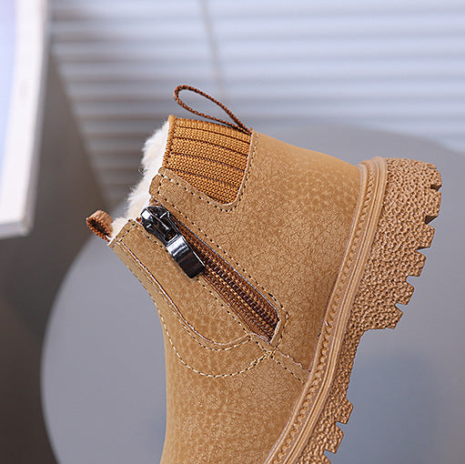 Brown boot with a zipper on a blurred background