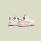 Pair of white sneakers with colorful accents on a light green background