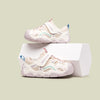 Pair of children's sneakers on a light green background