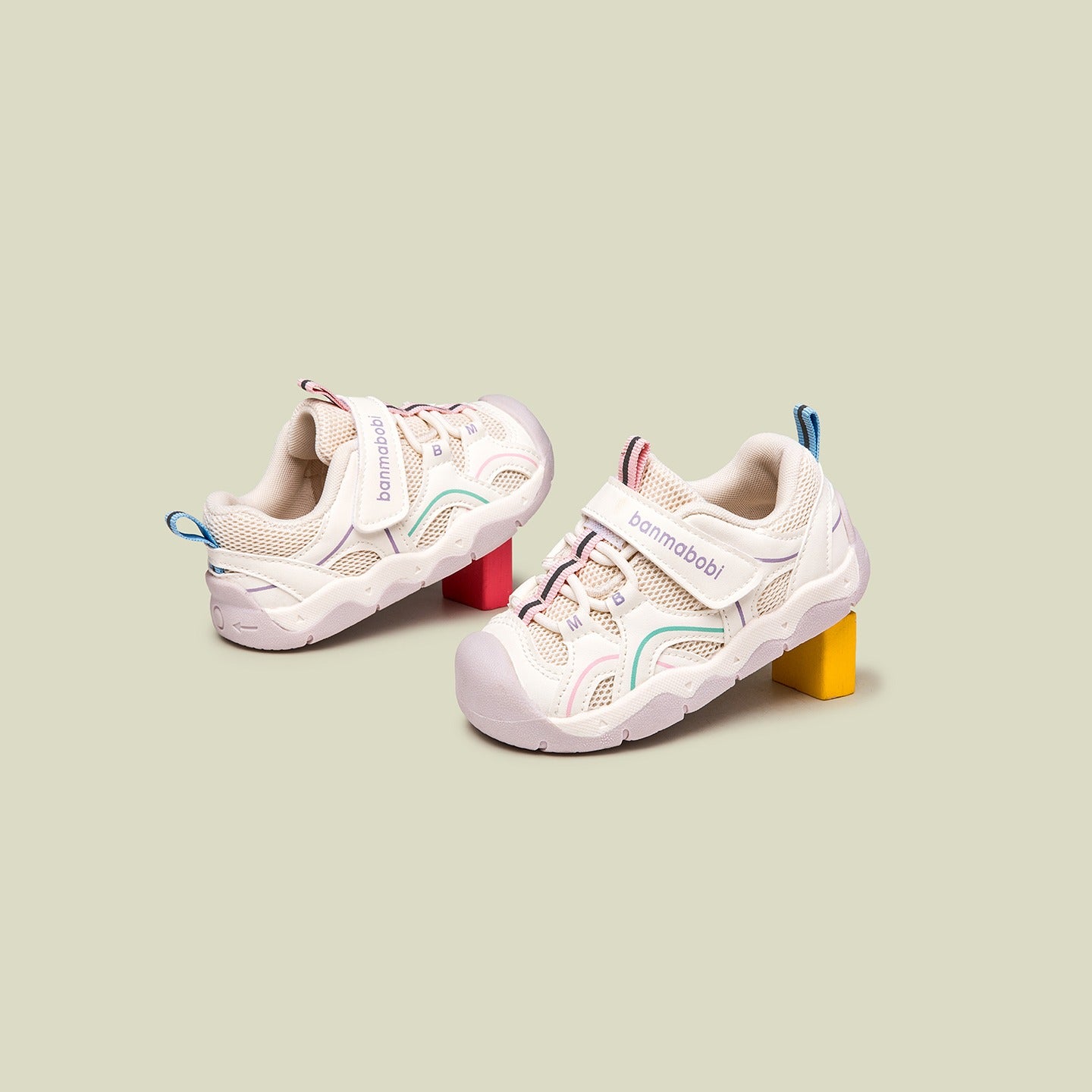 Pair of children's sneakers on a light green background