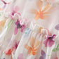 Close-up of a floral dress with colorful flowers and ruffles from Crazy Toes