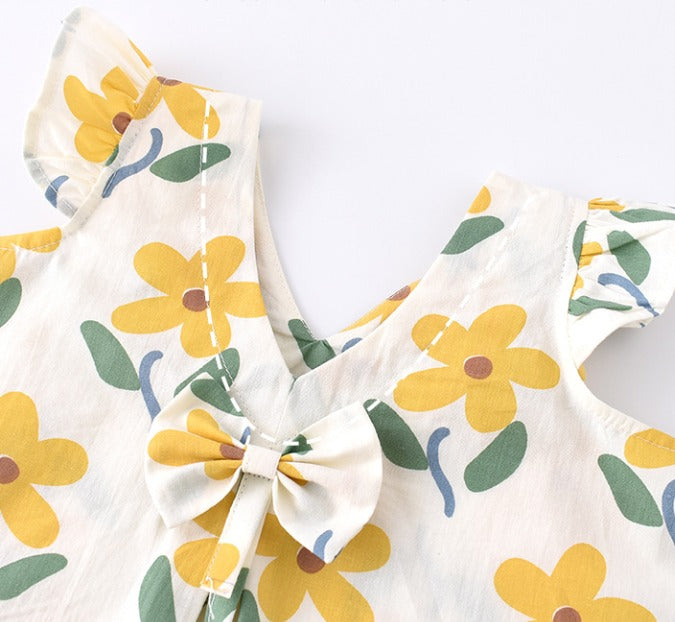 Floral-patterned fabric with yellow flowers and green leaves on a white background
