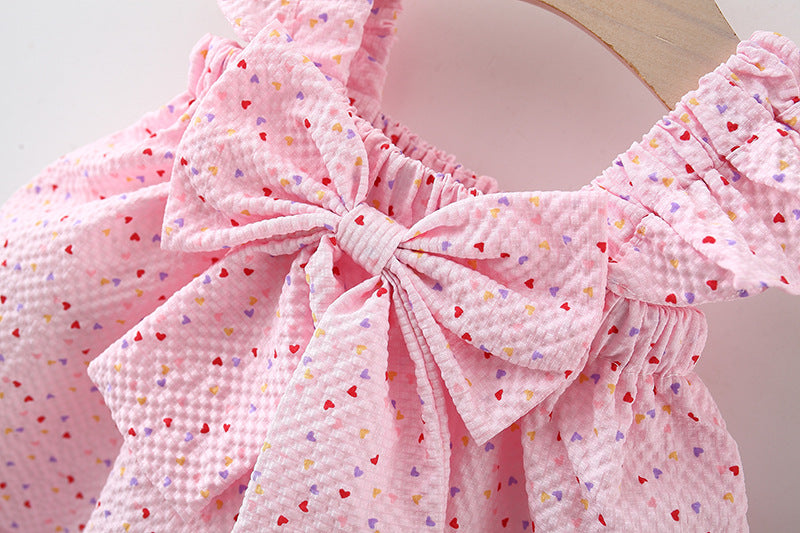 Pink dress with a large bow and heart pattern 