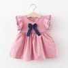 Pink dress with a blue bow on a white background