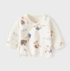 A baby long-sleeve wrap top in cream with a cute cartoon animal print, shown flat on a light gray background.