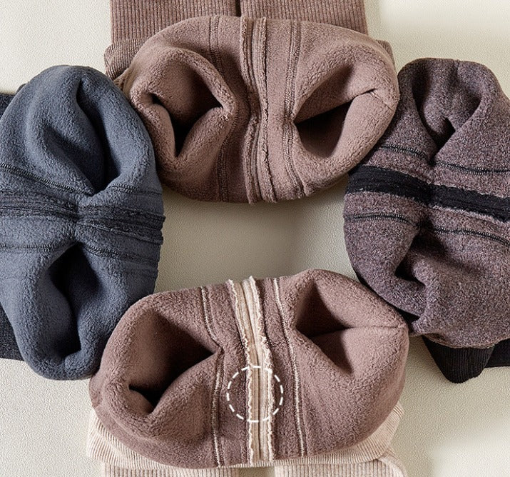 Four pairs of soft, textured socks in different colors on a light background.