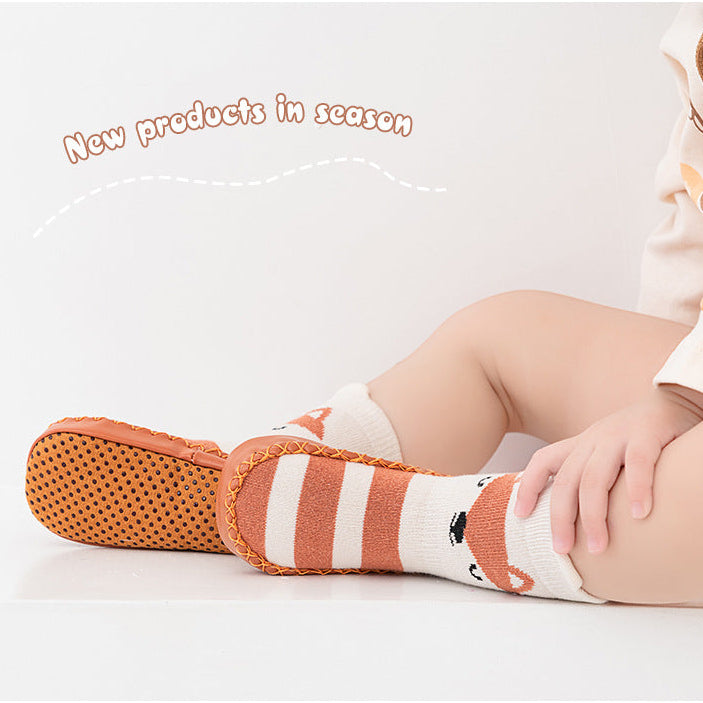 Baby wearing striped socks with a fox design on a white background