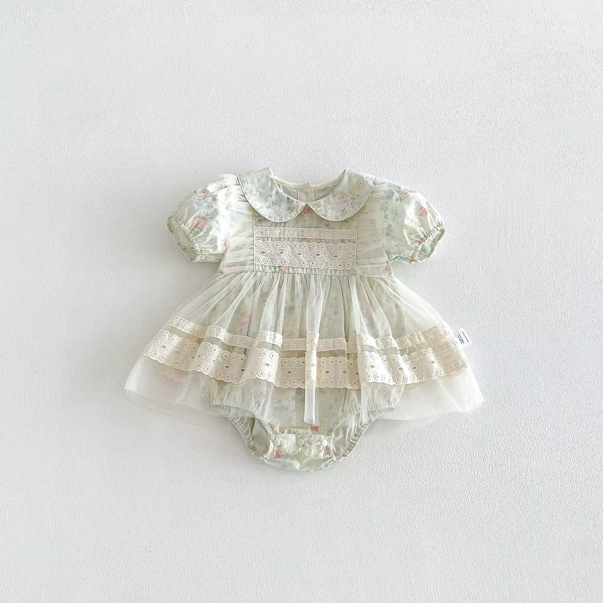 Baby dress with floral pattern on a white background