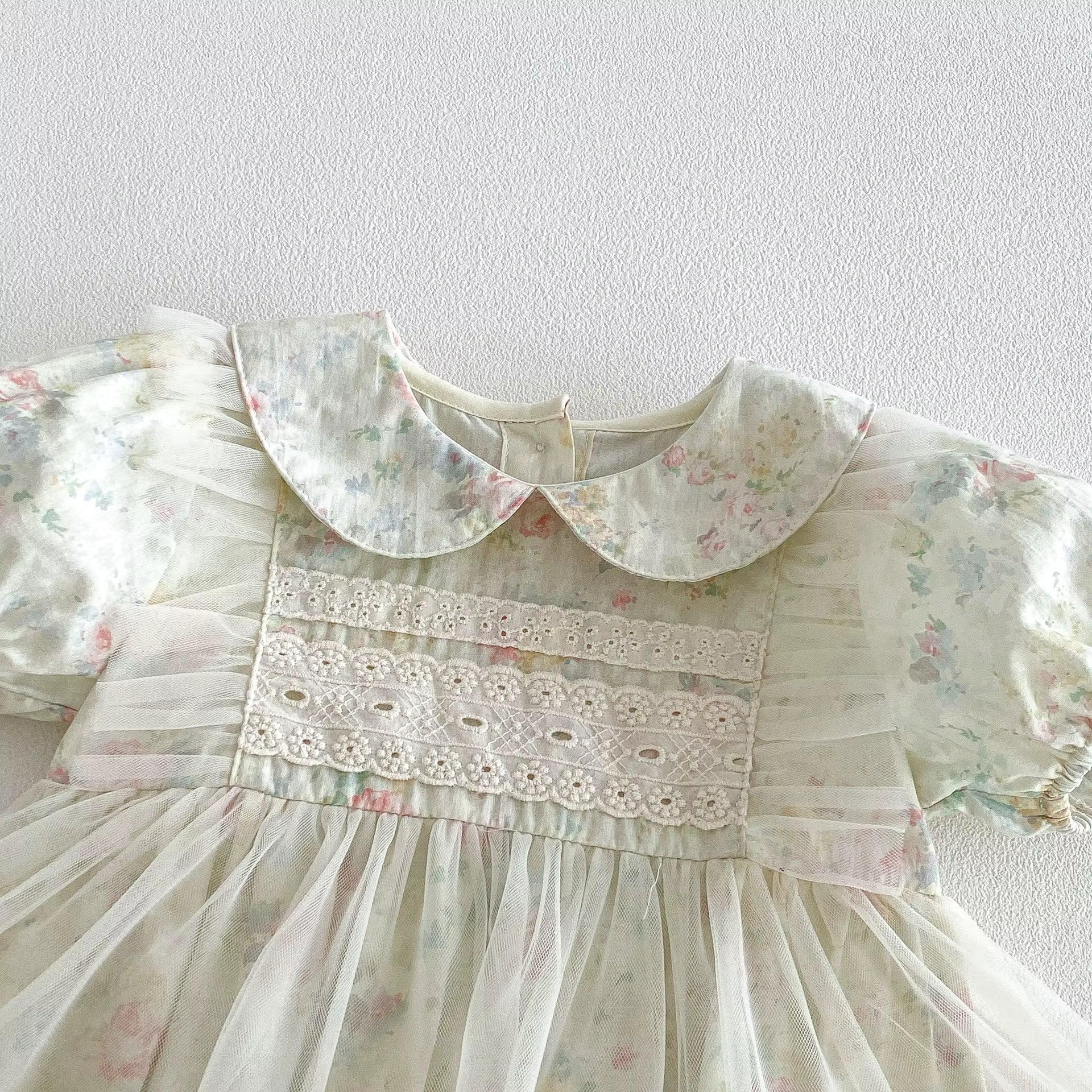 Floral dress with lace details on a white background
