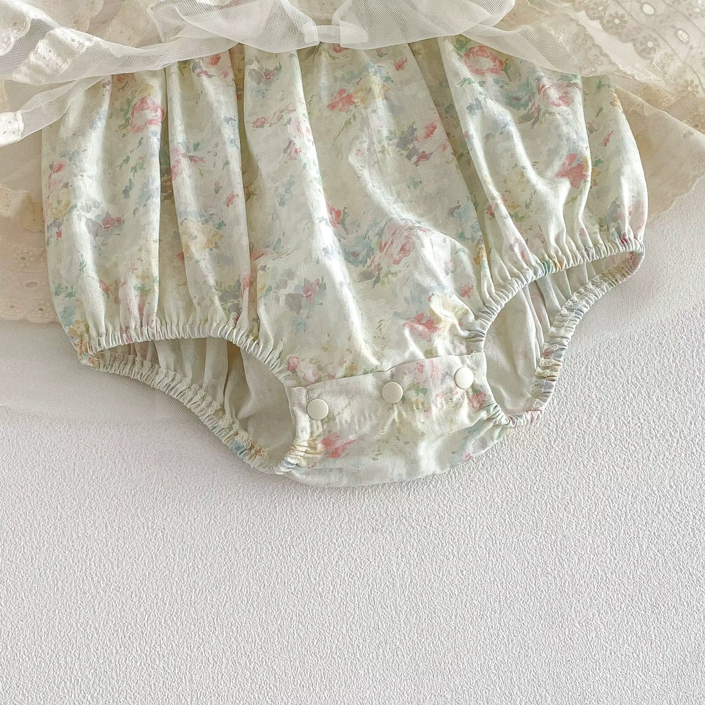 Floral-patterned baby bloomers on a white background
