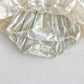 Floral-patterned baby bloomers on a white background