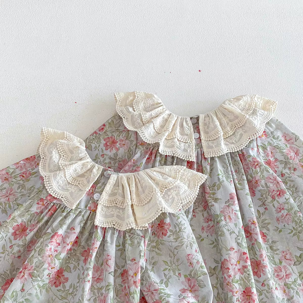 Floral dress with lace details on a white background